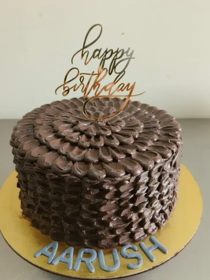 The full view of this beautifully textured chocolate birthday cake.