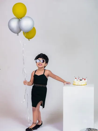 A cool and stylish birthday girl with her cake and balloons. We can create any vibe you're looking for, from playful to chic.