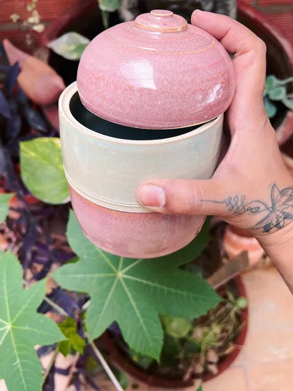 A pink and cream lidded jar, perfect for storing spices or trinkets. Each piece is made with love and care.