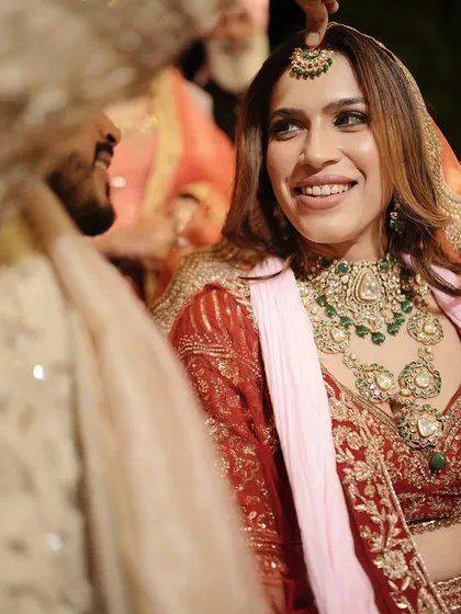 A close-up of the bride and groom. Her makeup is designed to look flawless both in person and in photos, enhancing her features without overpowering them.