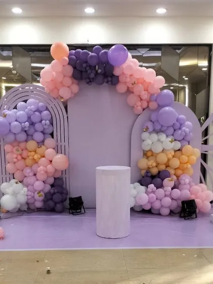 Another angle of the lavender butterfly-themed first birthday. This view shows the full stage setup, including the placement of the cake pedestal, ready for the main event.