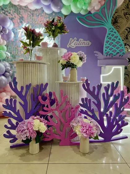 Details from our mermaid party, including glittery coral props and beautiful floral arrangements in purple and pink.