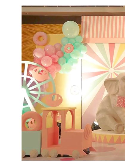 A pastel train prop and a Ferris wheel, part of our whimsical candyland and carnival setups.