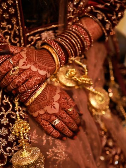 A stunning stain shot against a rich velvet bridal lehenga. The dark henna provides a beautiful contrast.