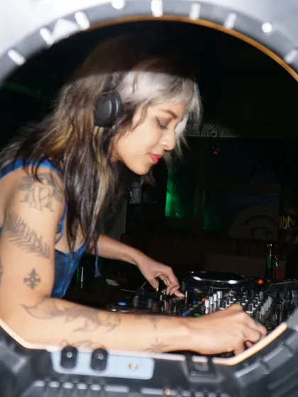 A cool shot through a ring light, capturing me focused on the mix.