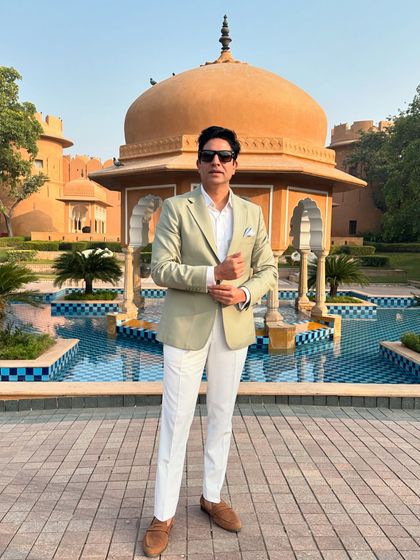 A sharp, stylish look in front of a beautiful heritage building in Jaipur. The architecture and ambiance of the Pink City are perfect for grand Indian weddings.