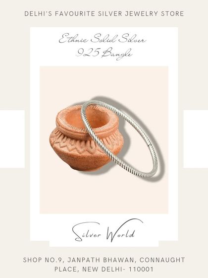 A sleek, twisted, or 'rope' style solid silver bangle. This is an ethnic design that is both simple and elegant.