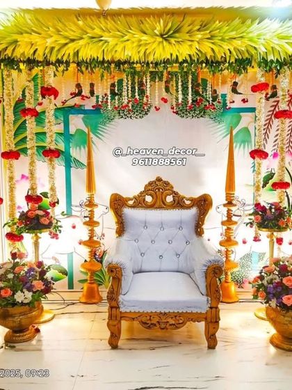 This vibrant setup is perfect for a baby's first birthday or a naming ceremony. It features a canopy of yellow flowers, hanging garlands, and traditional brass urlis filled with floral arrangements.