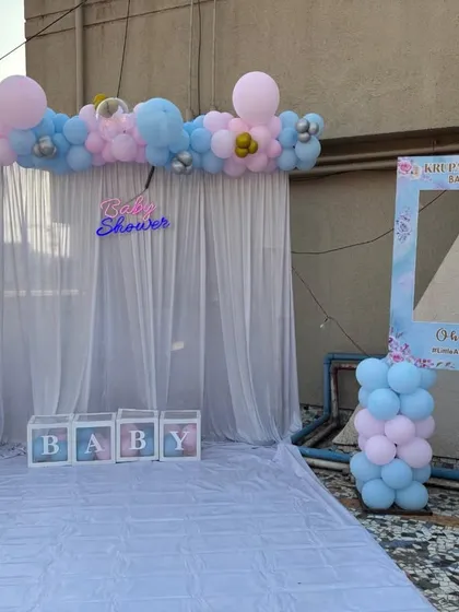 The full view of our terrace baby shower setup, including a custom selfie frame for guests to take fun pictures.