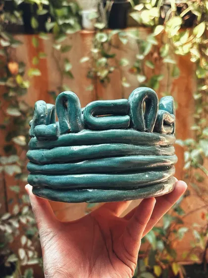 Congratulations to this student on completing her beginner's course. She created a beautiful collection, including a tall vase with leaf imprints and a lovely coiled bowl.