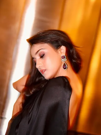 This soft, dreamy shot highlights the gentle contouring and the shimmer on the eyelids.