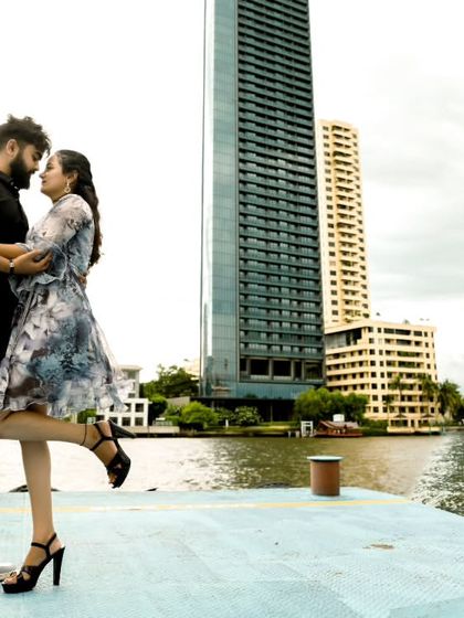 A modern, urban shot from the same Thailand trip, showing a couple against the Bangkok skyline by the river.