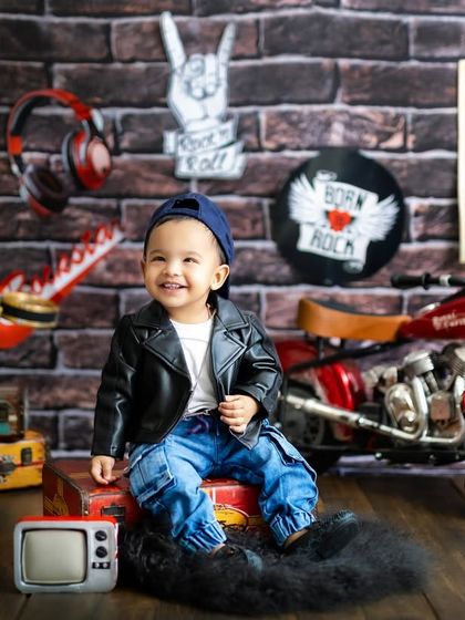 Born to be wild! This little dude is rocking his leather jacket and cool attitude in our fun, rock-and-roll themed studio setup.