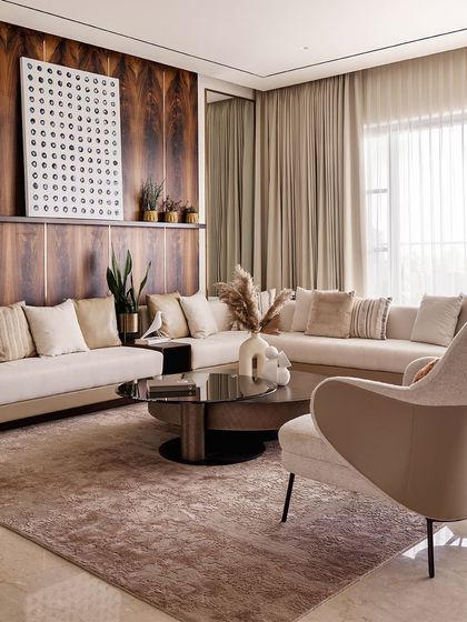 This view of the living area highlights the comfortable and inviting atmosphere. The soft textures of the rug and pillows, combined with the warm wood and natural light, create a space that is perfect for relaxing.