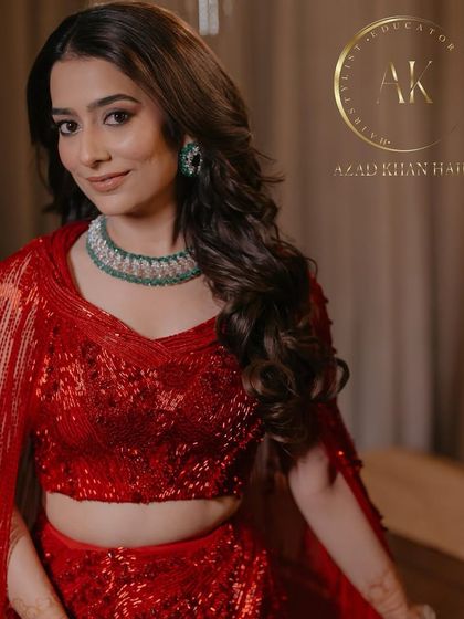 Glamour locks in a vibrant red outfit. The soft curls add a touch of romance to this bold and beautiful look.