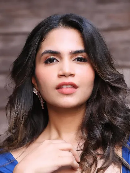 A portrait that captures the elegance of this simple yet stunning look. The makeup enhances her features beautifully.