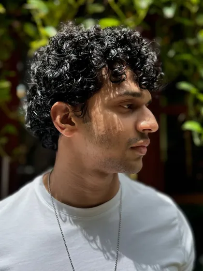 Curls for the win. This client's short, tight curls are perfectly defined and shaped for a stylish, effortless look that's easy to maintain.