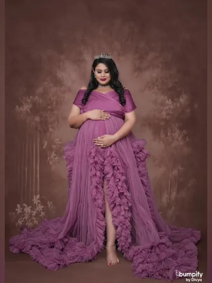 A full-length solo portrait against a classic painted backdrop. The rich texture of the background adds depth and artistry to the image.
