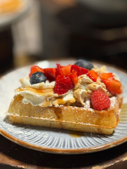 A freshly baked Belgian waffle loaded with whipped cream and mixed berries. Our waffle station uses an authentic recipe and chefs to deliver the perfect crispy, fluffy texture.