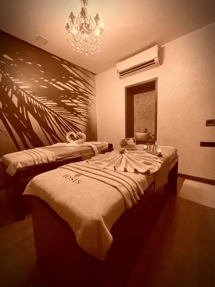 Welcome to your personal sanctuary. I've designed my treatment rooms to be a haven of peace and luxury, where you can truly disconnect. Notice the serene lighting, the plush, branded linens, and the elegant decor, all set for your complete relaxation.