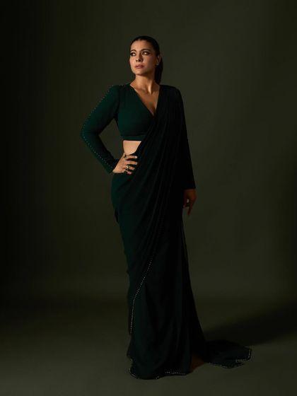 For an awards night, we created this custom dark green saree with a modern, full-sleeved blouse, exuding power and sophistication.