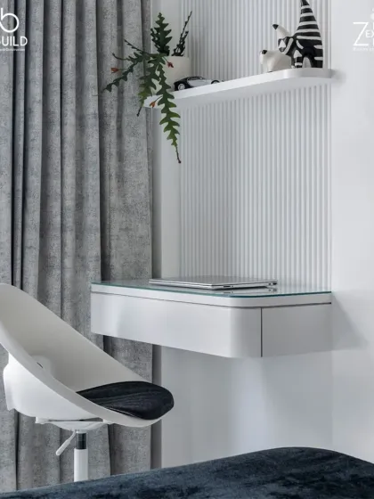 A minimalist study corner in 'The House of Arcs', featuring a sleek floating desk, a modern chair, and a simple shelf, all set against a wall with fluted details.