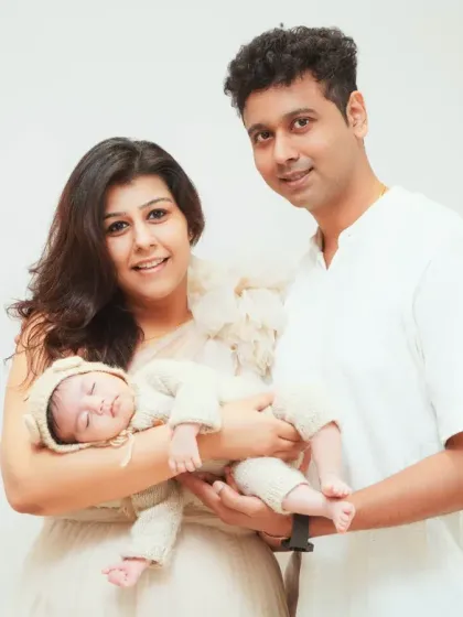 The first family portrait. This session captures the new family unit with their sleeping newborn, a priceless memory of when three became one.
