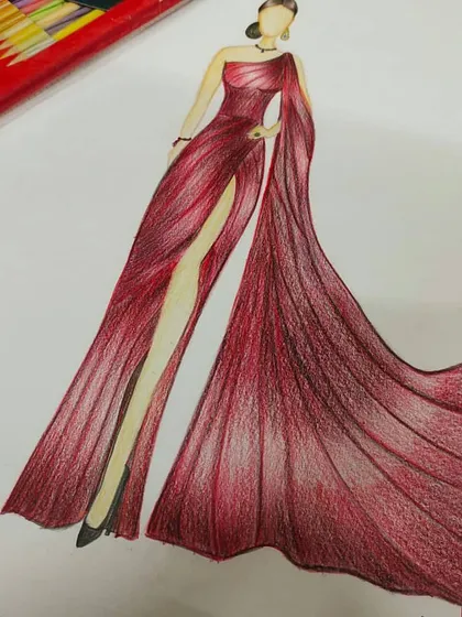 Every great design starts with an idea. In our fashion illustration course, students learn to translate their vision onto paper, mastering techniques to sketch flowing fabrics and elegant silhouettes like this stunning red evening gown.