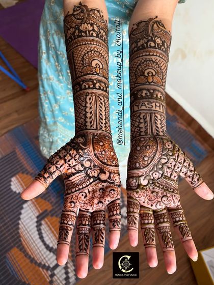 This bridal mehendi combines geometric jaali patterns with traditional motifs. I also personalized it by hiding the groom's name, "Yash," within the intricate design on the arm.