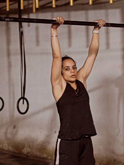 The dead hang is the foundation for all pulling movements. Here, a member demonstrates excellent grip and shoulder engagement, building the endurance needed for pull-ups and other advanced bar skills.