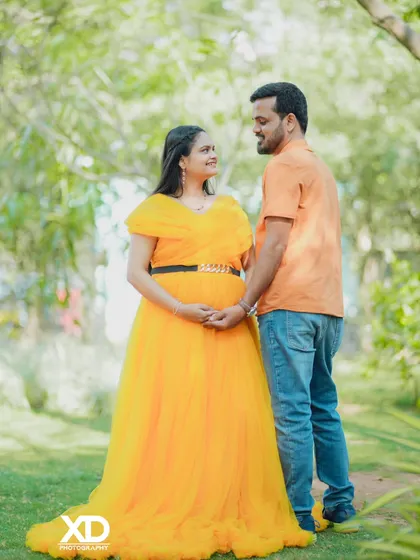 A sweet and happy couple's portrait, holding hands in a beautiful garden.