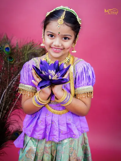 A sweet pose with her holding a lotus flower. This adds another layer of traditional symbolism and beauty to the portrait.