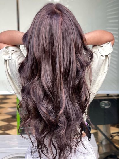 A stunning example of a finished balayage from the back, showcasing the seamless blend of colors and the healthy shine of the hair.