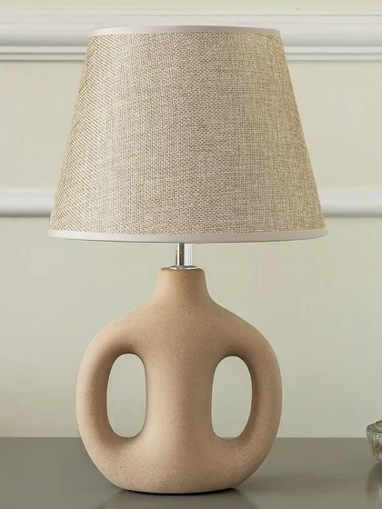 Lighting should also be art. This Artisan Loop Ceramic Table Lamp has a unique sculptural quality that makes it a decorative object even when turned off. The natural ceramic finish and simple shade make it a versatile piece for modern interiors.