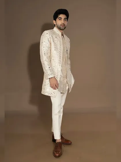 The full-length view of the ivory mirror-work jacket set, showcasing its luxurious and celebratory feel.
