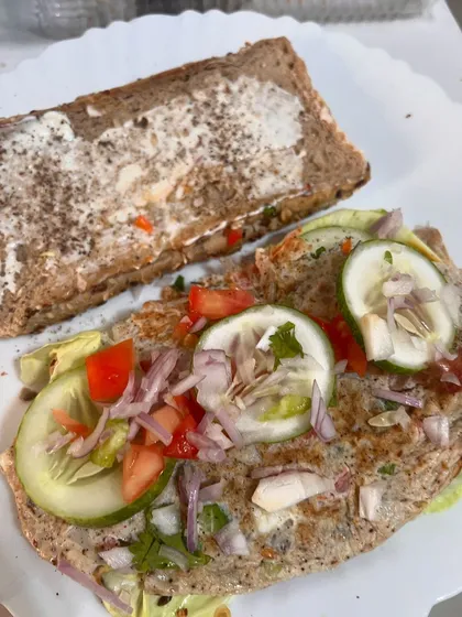 This is my idea of a perfect Sunday meal. A multigrain sandwich filled with a fluffy omelette, fresh lettuce, cucumber, tomato, and onion. It proves that a balanced breakfast is the first step to a balanced life.