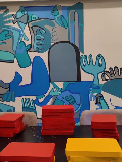 A mixed-media wall mural for a client in Ahmedabad, featuring abstract shapes in cool blue tones. The piece incorporates both painted surfaces and 3D elements.