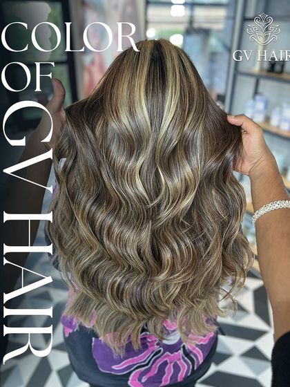 You may fall in love with our hair color. This look features a beautiful blend of blonde highlights on a brown base, styled in soft waves.