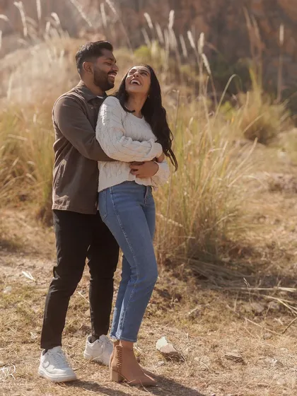 This is the kind of pure joy I love to capture. A big, happy laugh during their engagement session in a field in Delhi. It's these unposed, real moments that truly show a couple's personality.