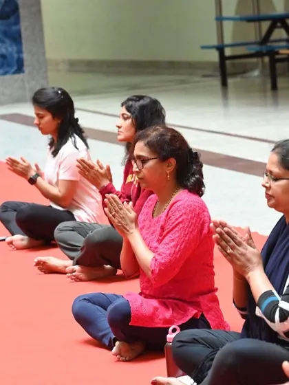 Participants in a corporate yoga session are seen here in a moment of quiet reflection. Even a short session can create a peaceful atmosphere and help team members connect with themselves.