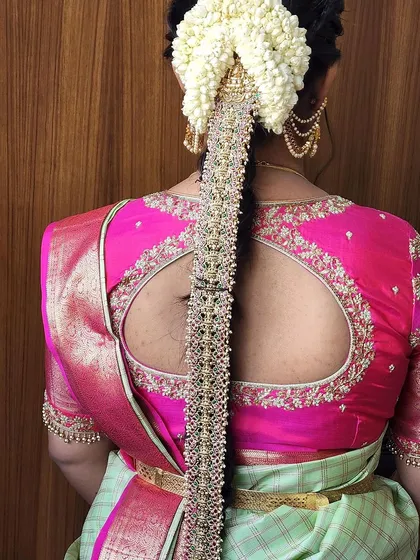 A close-up of a pearl-studded hair braid ornament. The delicate pearls and intricate design make this a popular choice for brides and wedding guests alike.
