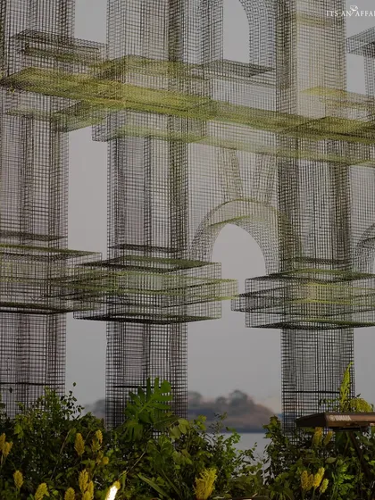 An artistic shot of the complex mesh structures, designed to look like architectural sketches against the sky, adding an industrial-chic element.