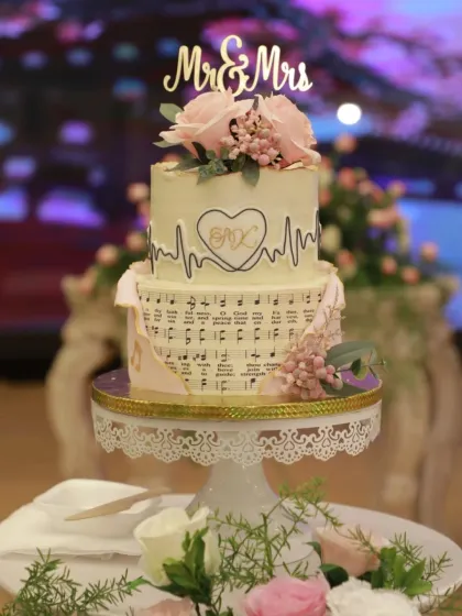 This cake is a perfect example of how I bake your story into a design. Created for a doctor and a musician, the top tier features a heartbeat EKG line, while the bottom tier is wrapped in edible sheet music, blending their two passions perfectly.