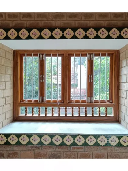 A window detail, framed with beautiful, traditional handmade tiles, set within an exposed brick wall.