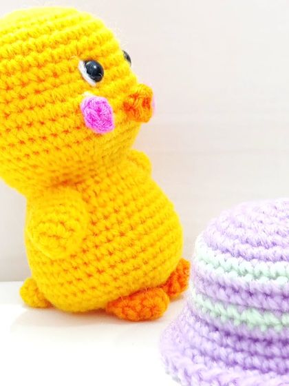 Duke standing next to his tiny lavender hat.