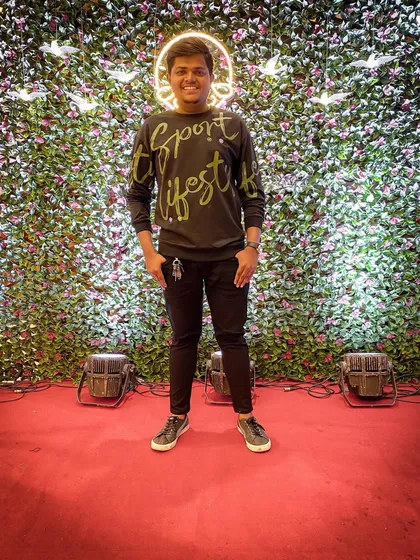 Standing on the stage I helped create. Beyond the music, my event management service includes coordinating stage design and lighting to build a complete, professional party environment.