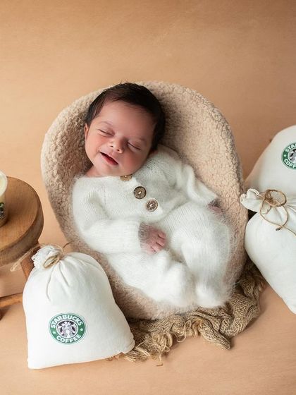 When mom and dad own a coffee plantation, a Starbucks theme is a must! This little one is smiling in his sleep, dreaming of his first puppuccino.