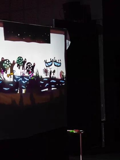 The magic of shadow puppetry comes to life on the screen. The children created this entire scene, from the characters to the backdrop.