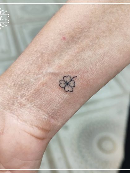 A tiny four-leaf clover on the wrist for good luck. This is a classic minimal tattoo, and we make sure the lines are clean and crisp, no matter how small the design.