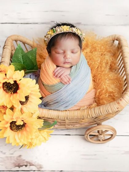 All of the beautiful colors for this little darling angel. Using a multi-colored wrap adds a touch of vibrancy while still keeping the setup classic and focused on the baby.